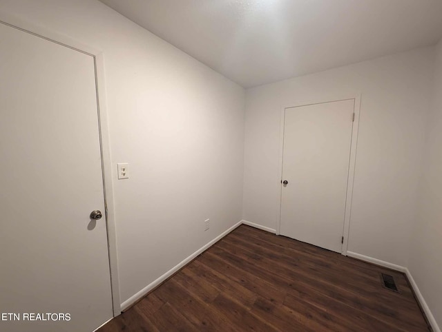 spare room featuring dark hardwood / wood-style flooring