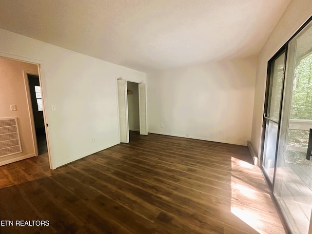 empty room with dark hardwood / wood-style floors