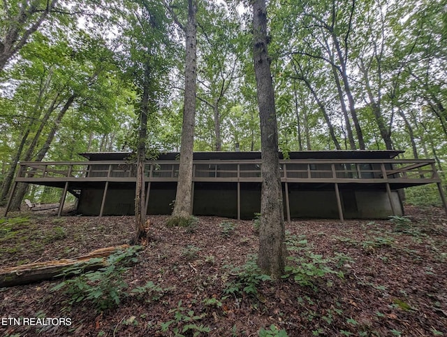 back of property featuring a deck