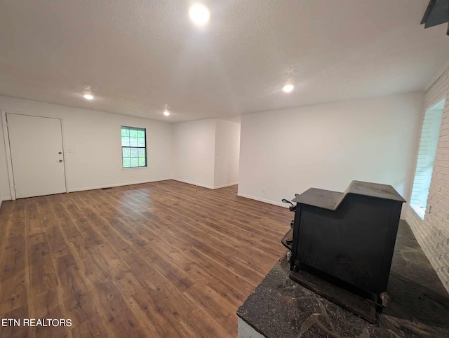 basement with dark wood-type flooring and a textured ceiling