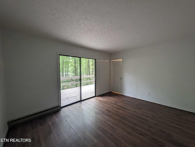 unfurnished room featuring dark wood-type flooring and a textured ceiling