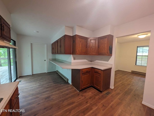 kitchen featuring baseboard heating, a wealth of natural light, and dark hardwood / wood-style floors