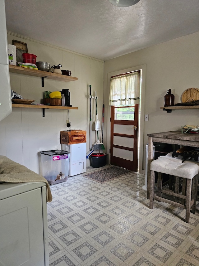 interior space with washer / clothes dryer and a textured ceiling