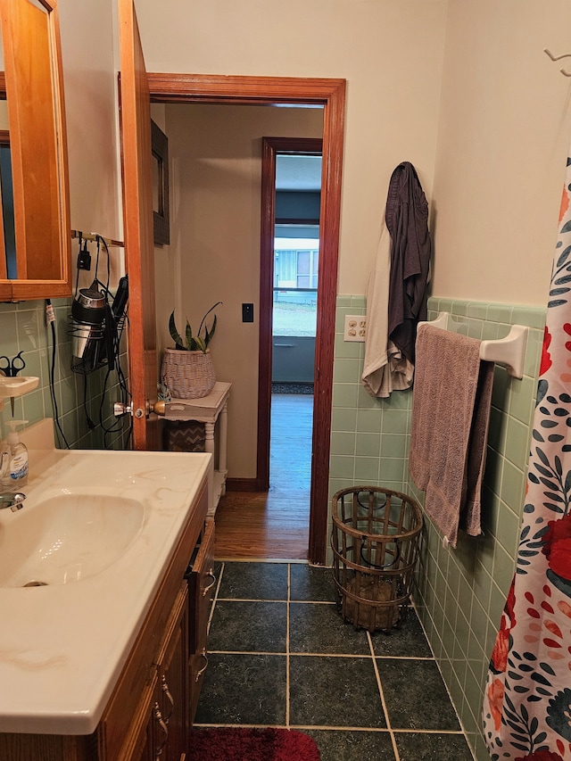 bathroom featuring tile walls, hardwood / wood-style flooring, and vanity