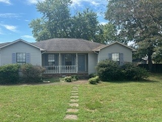 view of front of house with covered porch and a front lawn