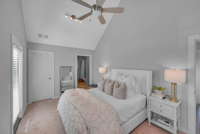 carpeted bedroom featuring high vaulted ceiling and ceiling fan