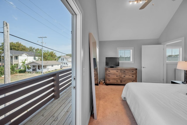 carpeted bedroom with multiple windows, vaulted ceiling, and ceiling fan