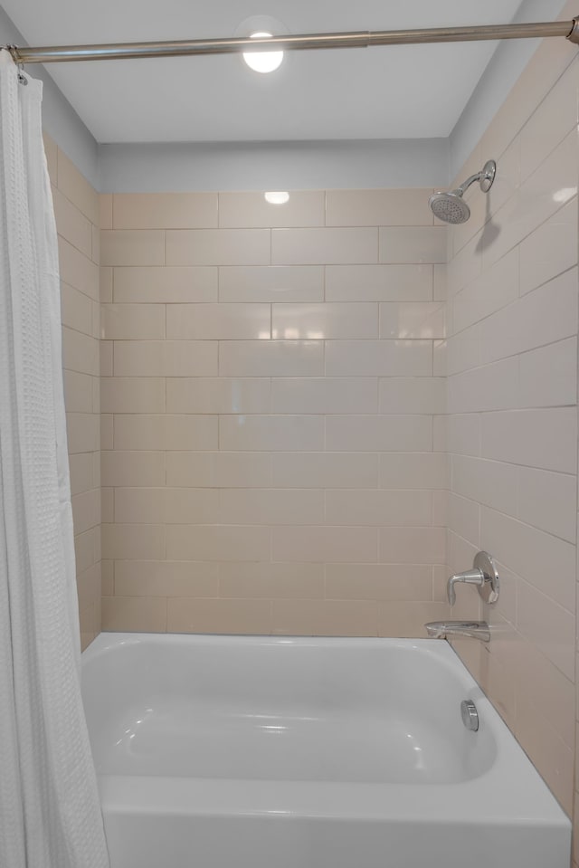 bathroom with shower / bath combination with curtain