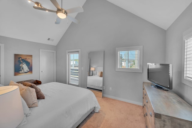 carpeted bedroom with high vaulted ceiling, multiple windows, and ceiling fan