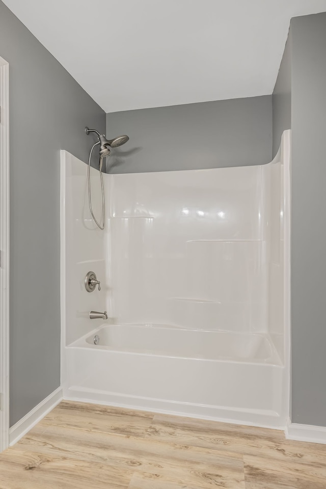 bathroom featuring bathtub / shower combination and hardwood / wood-style flooring