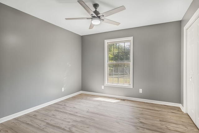 unfurnished bedroom featuring ceiling fan, a closet, and light hardwood / wood-style floors