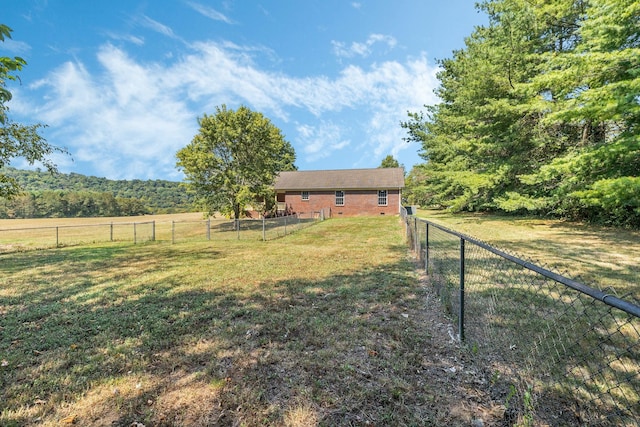 view of yard with a rural view