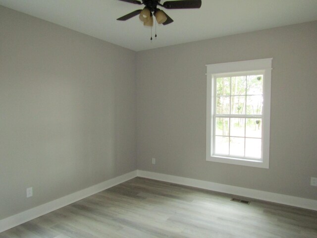 empty room featuring light wood-type flooring and ceiling fan