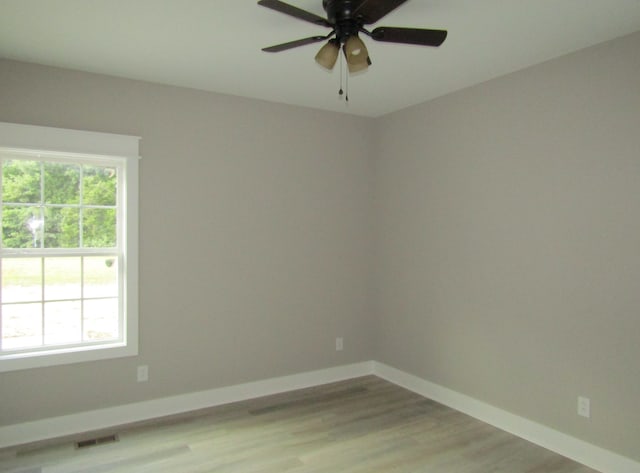 unfurnished room featuring hardwood / wood-style floors and ceiling fan