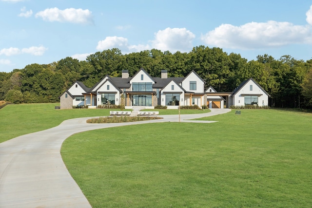 view of front of home with a garage and a front lawn