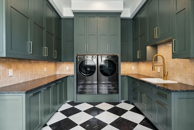 washroom featuring cabinets, sink, and washing machine and clothes dryer