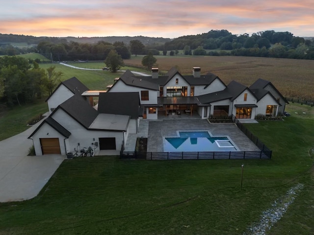 aerial view at dusk featuring a rural view