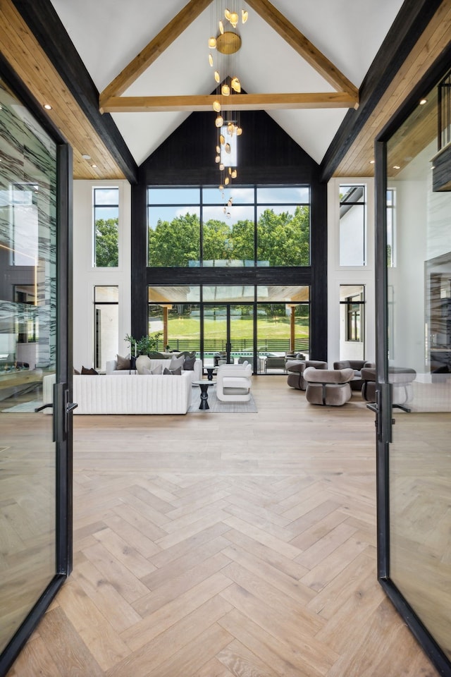 sunroom / solarium with a chandelier and lofted ceiling with beams