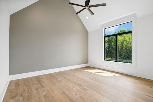 spare room featuring ceiling fan, lofted ceiling, and light hardwood / wood-style flooring