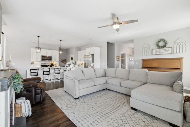 living room featuring ceiling fan and light hardwood / wood-style flooring