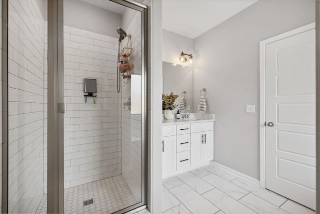 bathroom with a shower with shower door and vanity