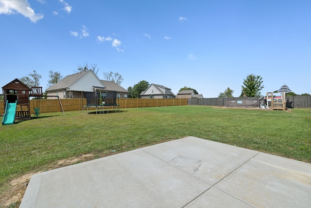 view of yard featuring a playground, a patio, and a trampoline