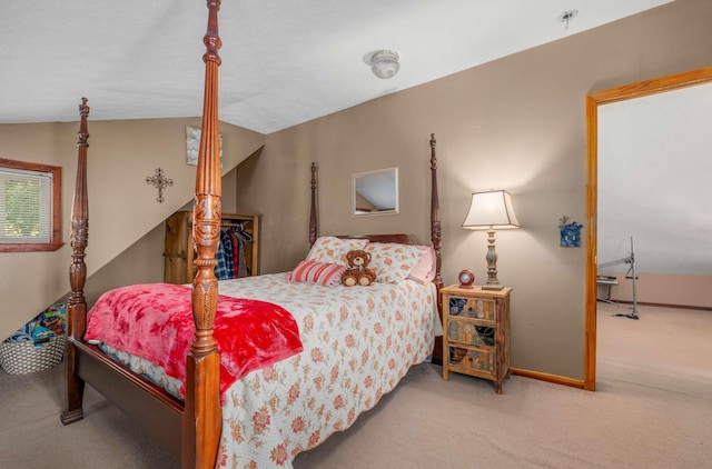 bedroom featuring carpet floors, lofted ceiling, and baseboards