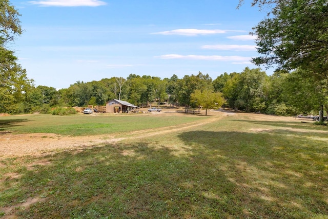 surrounding community featuring a forest view and a yard