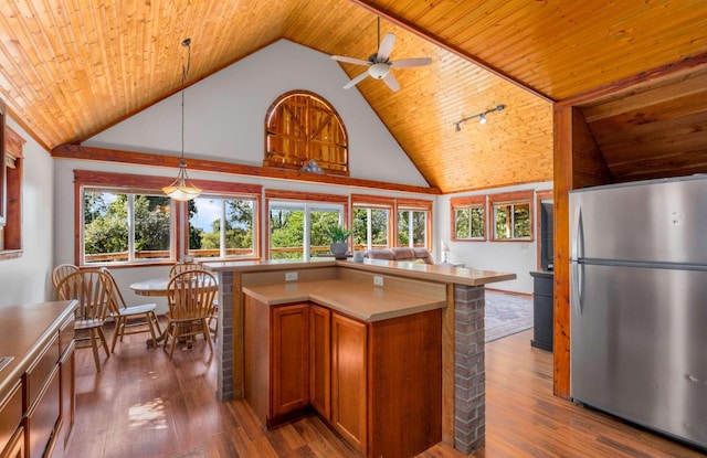 kitchen with dark wood-type flooring, freestanding refrigerator, wood ceiling, and brown cabinets