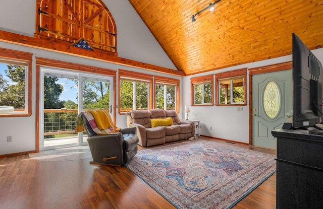 sunroom / solarium with wood ceiling, rail lighting, and vaulted ceiling