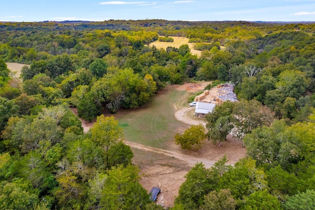 birds eye view of property featuring a view of trees