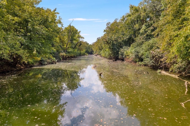 property view of water featuring a forest view