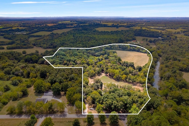 aerial view featuring a wooded view