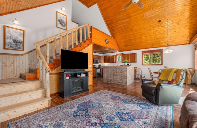 living room featuring wood ceiling, ceiling fan, stairway, dark wood-style flooring, and high vaulted ceiling