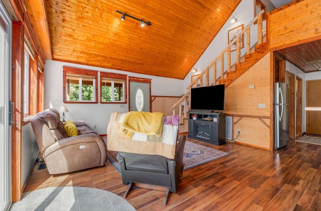 living area featuring rail lighting, wood ceiling, stairway, and wood finished floors