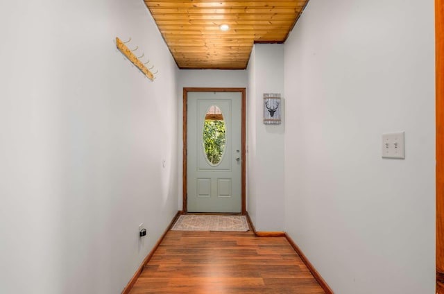 doorway featuring wood ceiling, baseboards, and wood finished floors