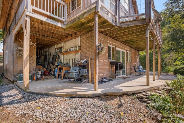 exterior space with a patio and brick siding