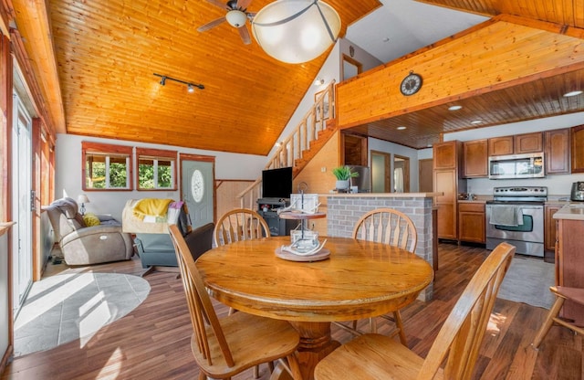 dining space featuring dark wood-type flooring, wooden ceiling, high vaulted ceiling, and track lighting