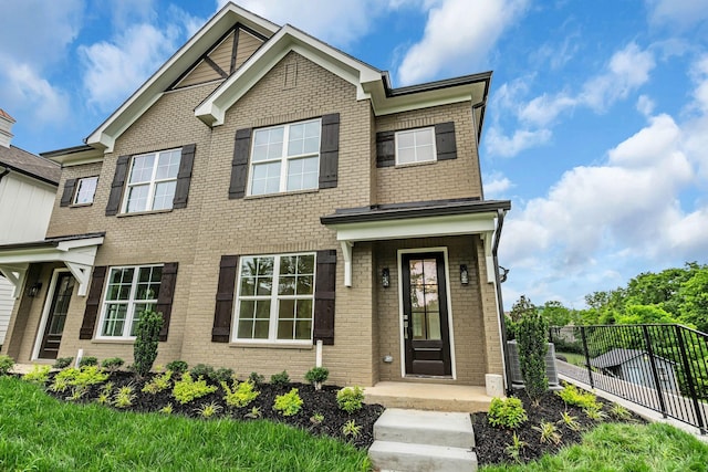 craftsman-style house with brick siding and fence