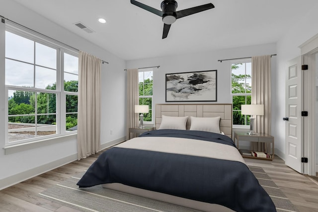 bedroom with ceiling fan, recessed lighting, visible vents, baseboards, and light wood-type flooring