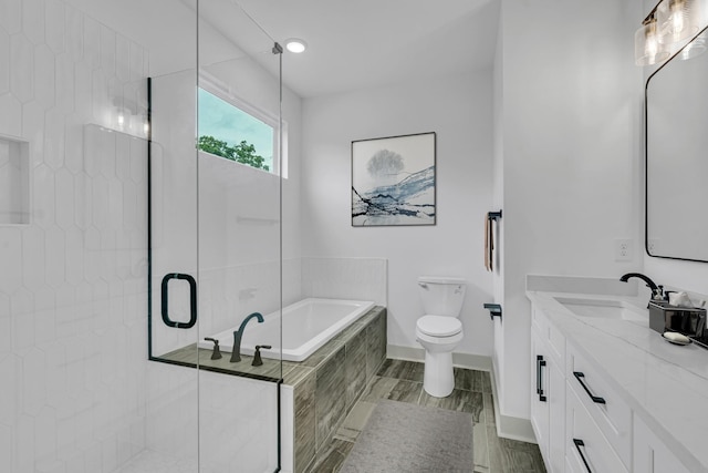 bathroom featuring toilet, vanity, baseboards, a shower stall, and a bath