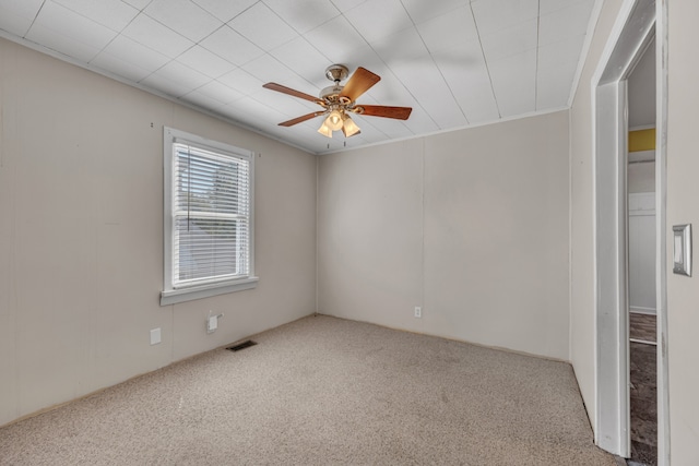 carpeted empty room with ornamental molding and ceiling fan