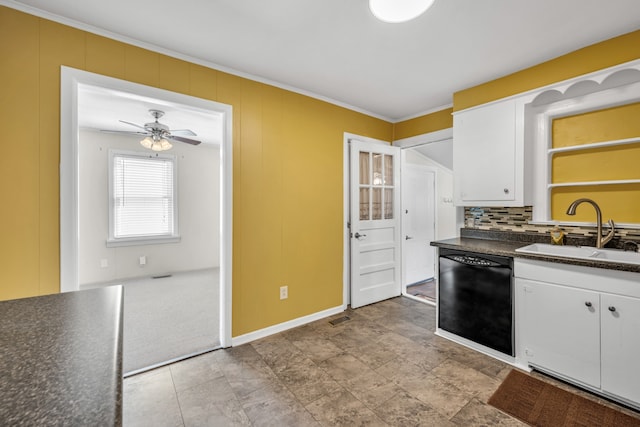 kitchen with black dishwasher, sink, white cabinetry, light colored carpet, and ceiling fan