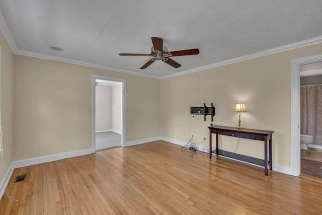 unfurnished room featuring crown molding, ceiling fan, and light wood-type flooring