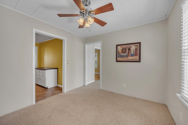 carpeted empty room featuring ceiling fan