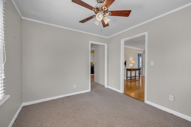 empty room featuring crown molding, ceiling fan, and carpet floors