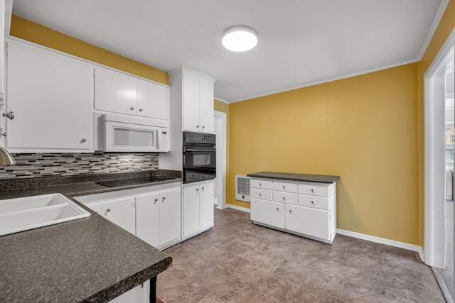 kitchen featuring black appliances, ornamental molding, sink, decorative backsplash, and white cabinets