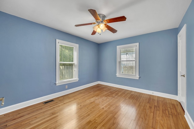 empty room with wood-type flooring and ceiling fan