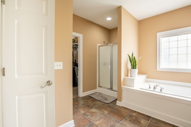 bathroom featuring tile patterned flooring and independent shower and bath