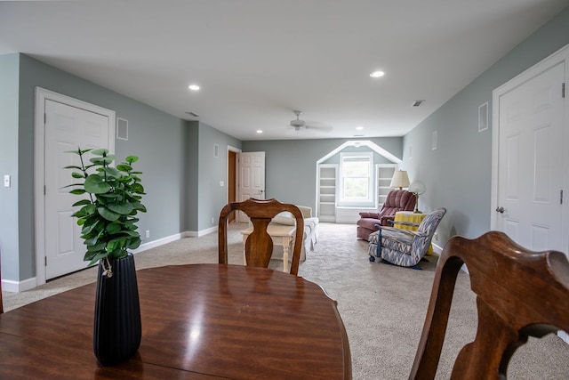 dining space featuring ceiling fan and carpet